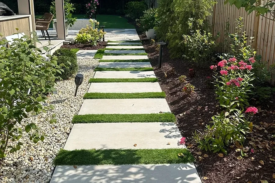 Porcelain stepping-stone path through planted garden beds